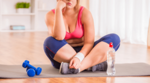frustrated woman sitting on yoga mat featured