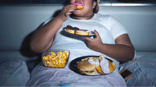 overweight woman binge eating junk food featured