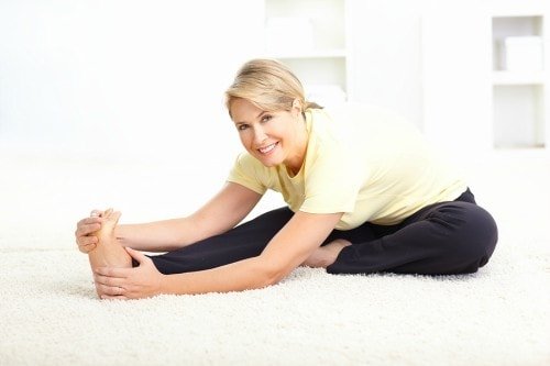 older woman smiling during yoga