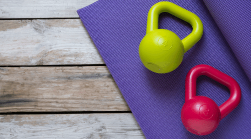 green and red kettlebells on a purple yoga mat featured