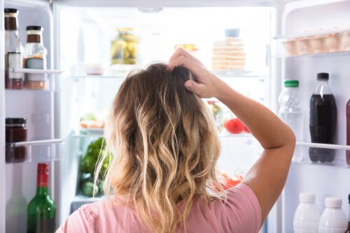 woman looking in fridge