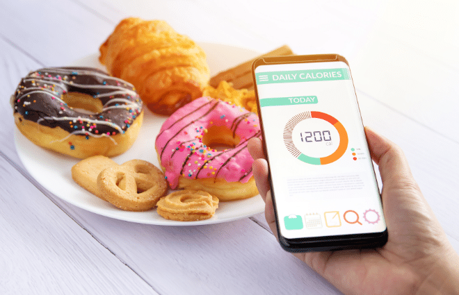 cell phone calorie counter with pastries, carbs, junk food