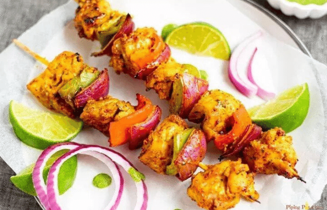 chicken tikka kabob with onions and limes