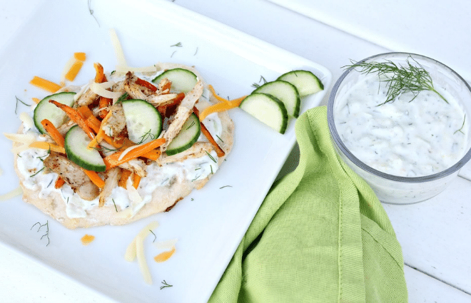 healthy greek pizza on plate with tzatziki sauce