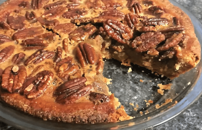 keto pecan pie with a slice missing