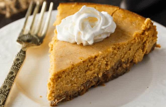 keto pumpkin cheesecake slice with whipped cream