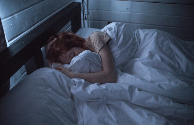 woman sleeping in dark room