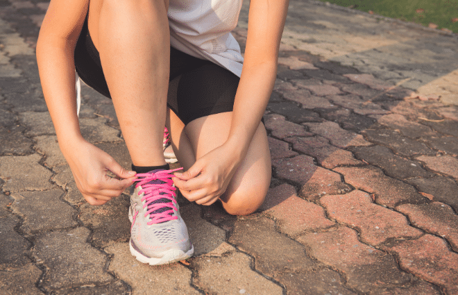 woman tying running shoes