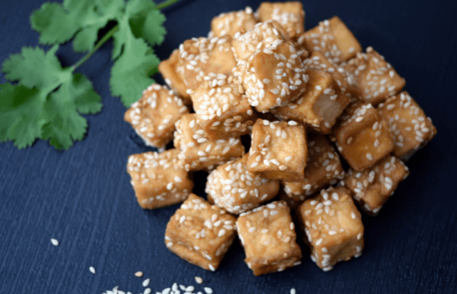 Cooked tofu with sesame seeds sprinkled on top
