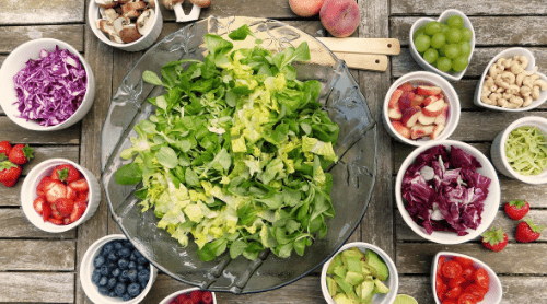 Vegan Diet Food Arranged Around a Salad Bowl - Featured