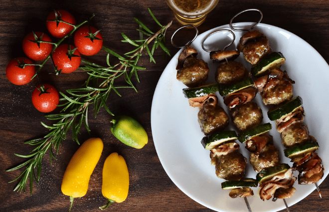 Kabob on a plate with herbs and vegetables
