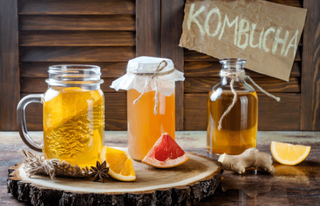 Kombucha bottles and fruit on a tray