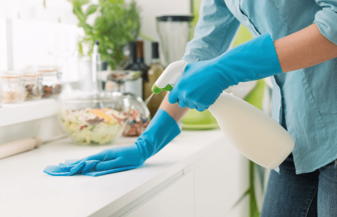 Woman cleaning a countertop doing chores