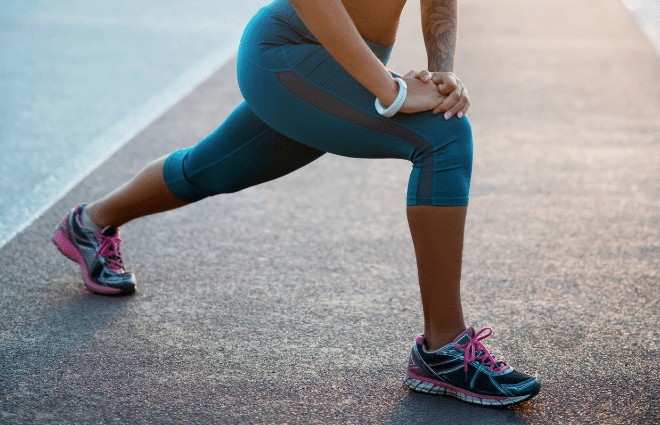 Woman doing lunge and working out without knee pain