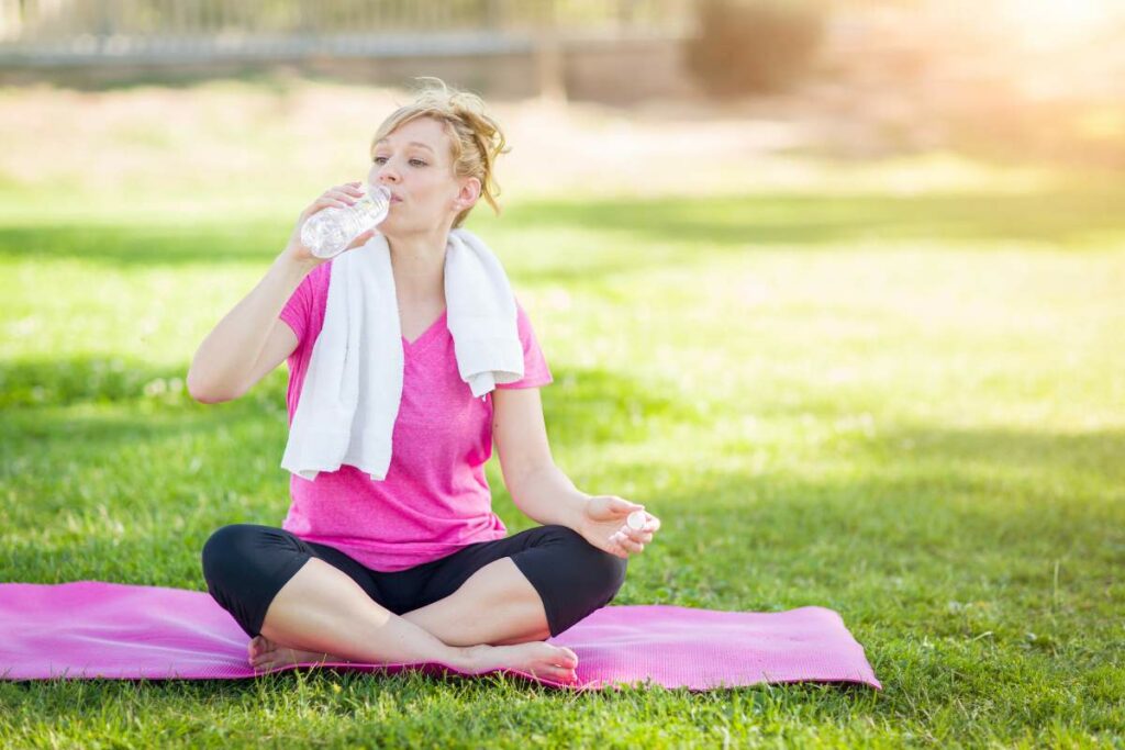 Beginners Guide to Yoga: Where to Start? woman drinking water