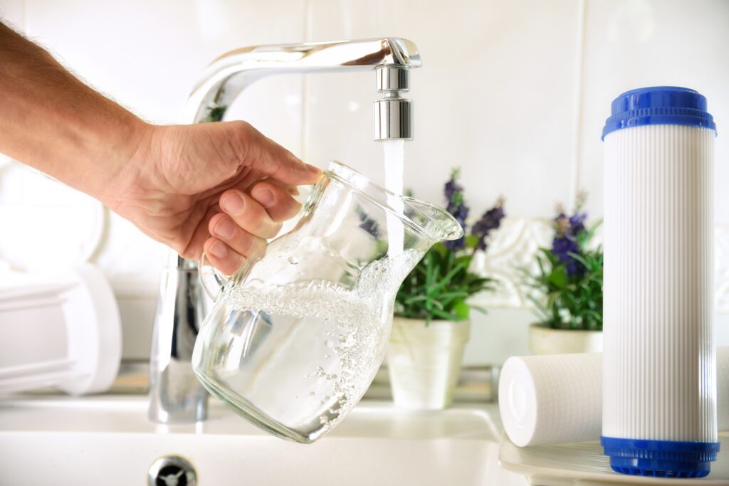 Man filling a glass jug
