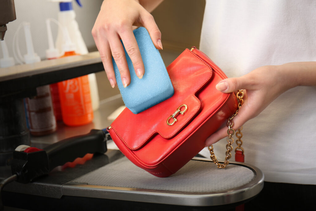 woman cleaing handbag with a sponge